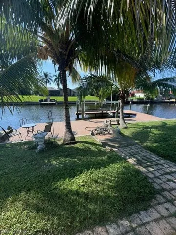 View of property's community featuring a water view and a yard