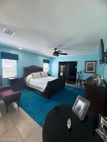Bedroom featuring ceiling fan and light tile patterned floors