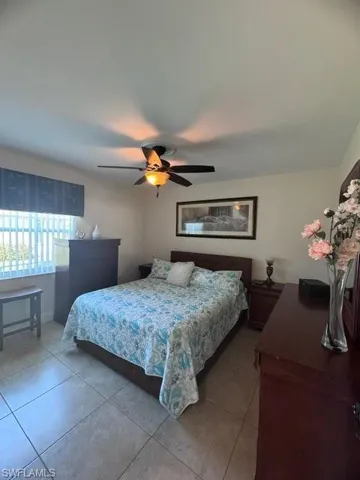 Tiled bedroom with ceiling fan