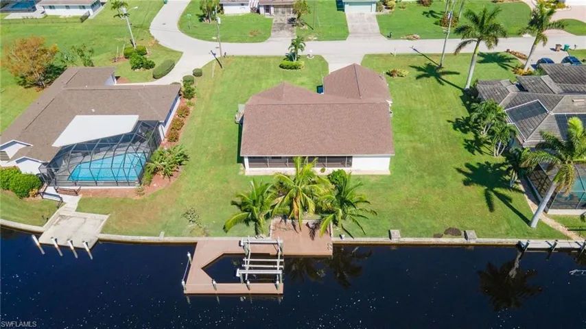Birds eye view of property with a water view