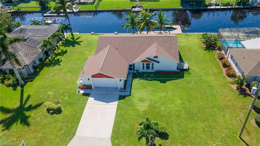 Birds eye view of property with a water view
