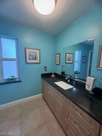 Bathroom featuring tile patterned flooring and vanity