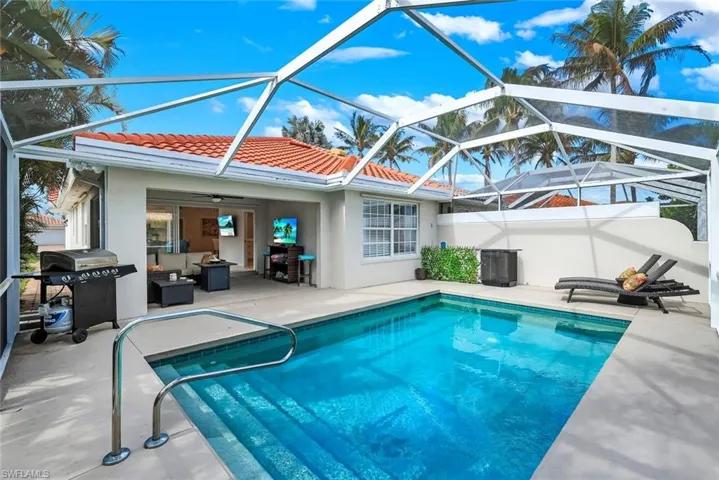 Outdoor pool featuring a patio, area for grilling, a sunroom, and a lanai