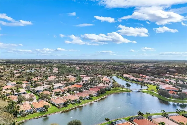 Aerial perspective of suburban area featuring a nearby body of water