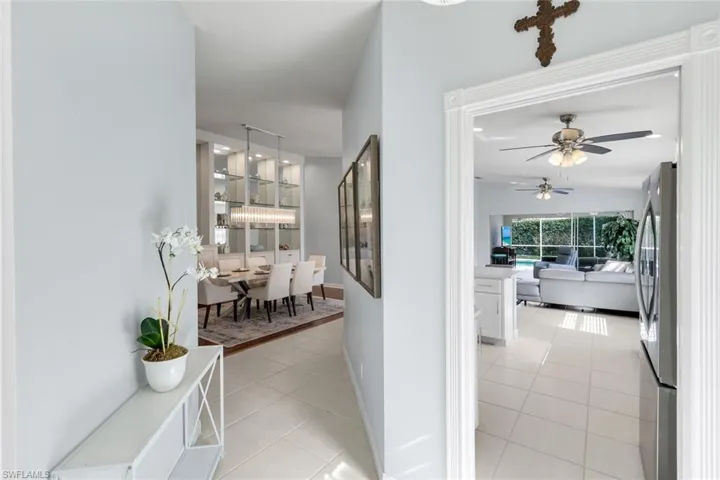 Hallway featuring light tile patterned floors