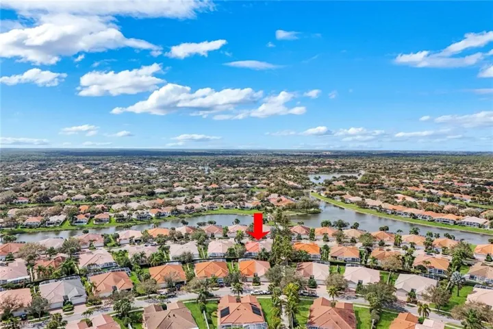 Aerial view of residential area featuring a nearby body of water