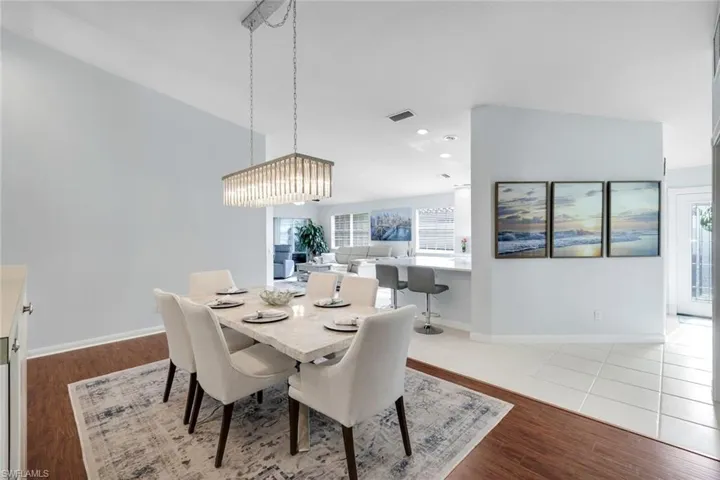 Dining space featuring dark wood finished floors and baseboards
