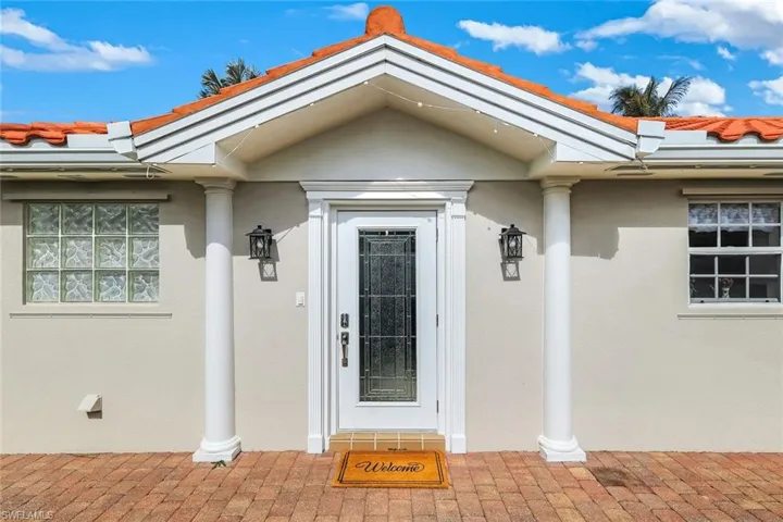 Entrance to property featuring stucco siding and a tiled roof