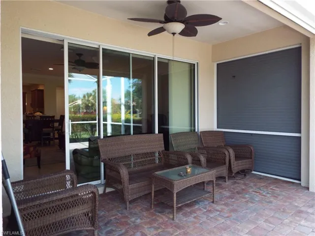 covered lanai with electric hurricane shutters and furniture