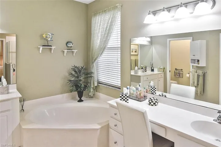 The primary bathroom has a Roman tub, separate walk-in shower, dual vanities, and private water closet.