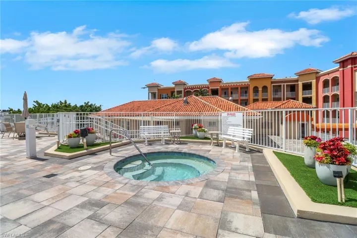 View of pool with a hot tub and a patio area