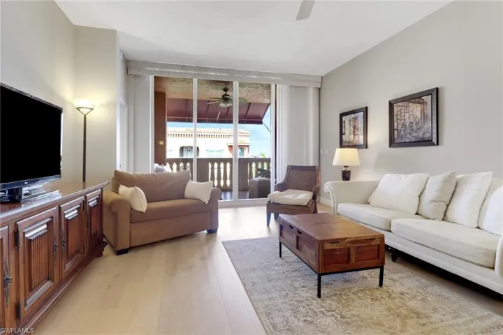 Living area featuring ceiling fan and light wood finished floors