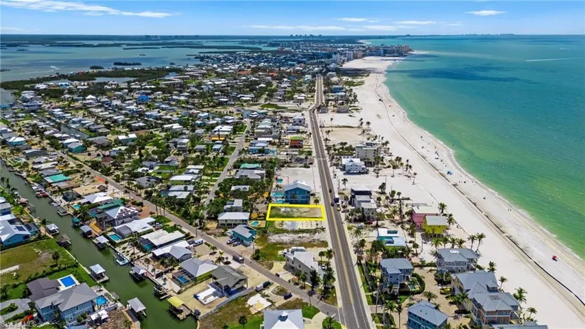 Birds eye view of property with a water view and a beach view  - Virtually Edited Image