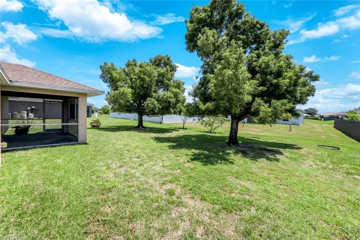 View of green lawn featuring a sunroom