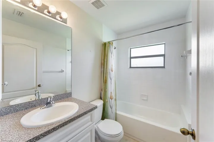 Bathroom with vanity and shower / bath combo