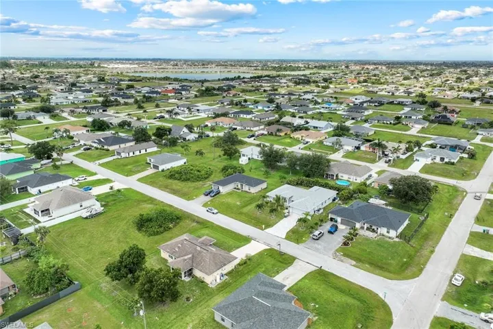 Aerial view of property's location with nearby suburban area and a nearby body of water