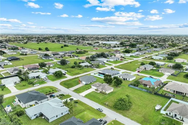 Aerial perspective of suburban area featuring a large body of water