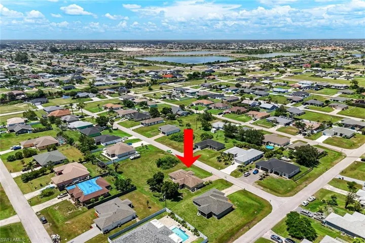 Aerial view of property's location featuring nearby suburban area