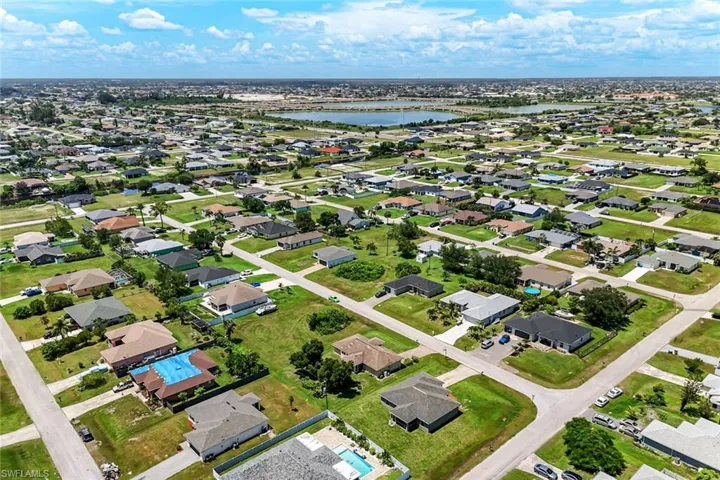 Aerial view of residential area featuring a nearby body of water