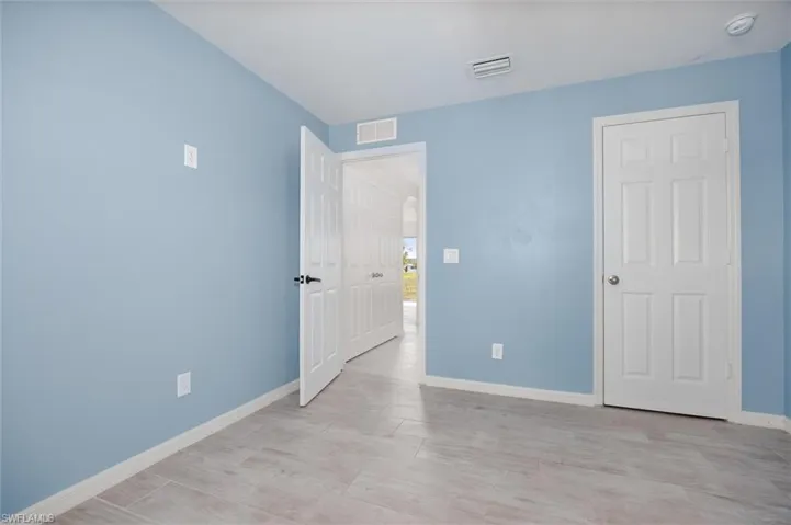 Unfurnished bedroom with baseboards and light wood-style flooring