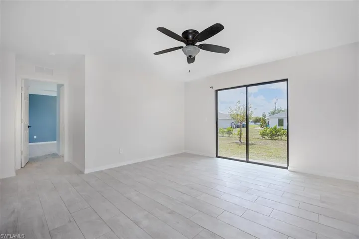 Unfurnished room featuring wood finish floors and a ceiling fan