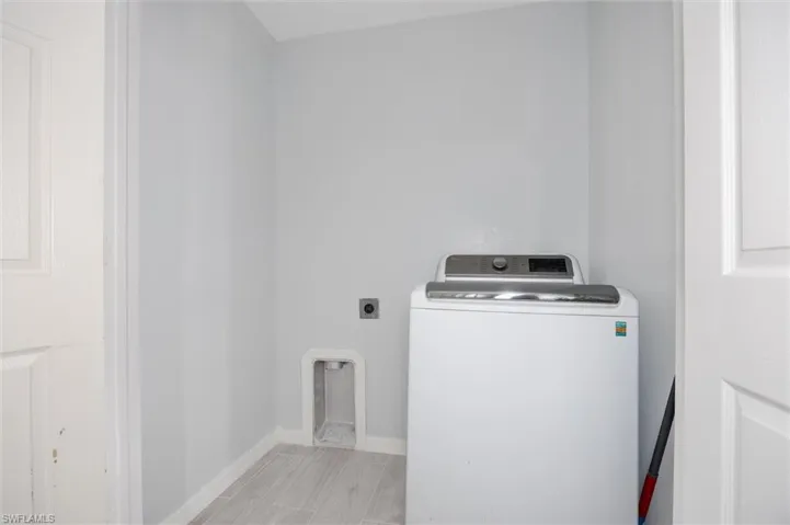 Laundry room featuring washer / dryer and baseboards