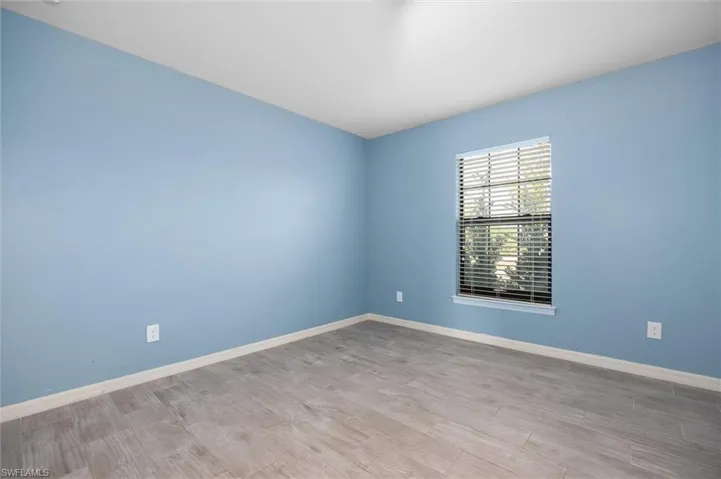 Spare room with light wood-type flooring and baseboards