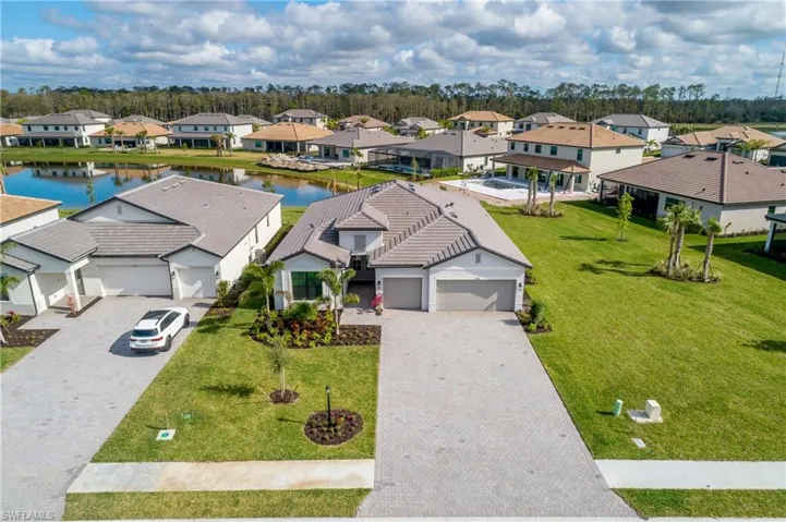 Oversized Lot with water view, extra long driveway, professional landscaping with privacy clusia at rear perimeter.
