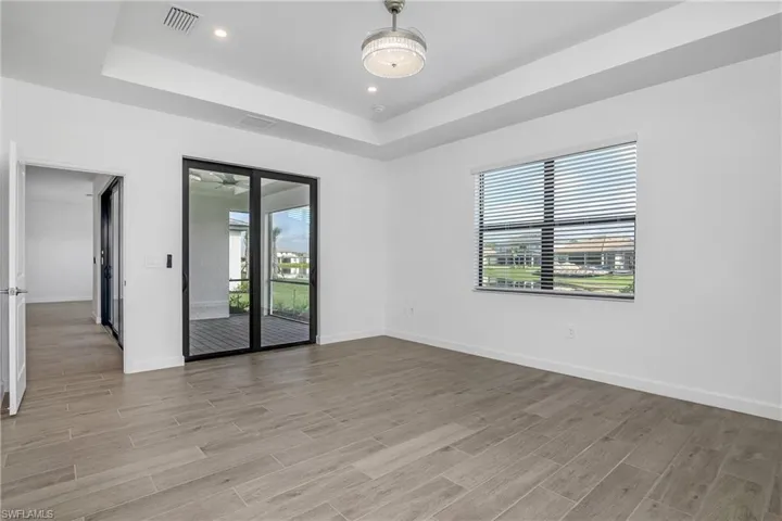 Primary bedroom includes sliding doors to the outdoor lanai space providing plenty of natural light.