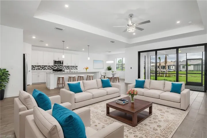 Enjoy seamless indoor/outdoor living with open great room featuring impact sliders, and large lanai. (furnishings digitally added)