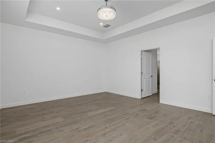 Primary bedroom is spacious and includes additional recessed lighting, chandelier/ceiling fan, and spa-like bath.