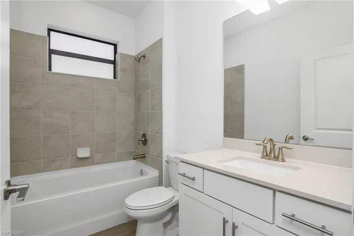 Guest Bathroom features tub/shower and large vanity.