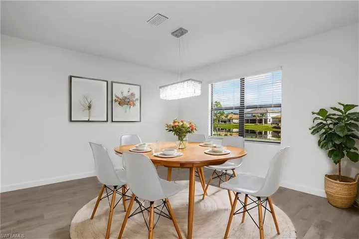 Family dining space is located just off the kitchen and features designer lighting and plenty of natural light. (furniture digitally added)