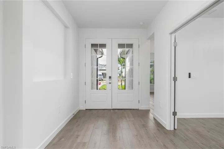 Open and inviting entryway with double, glass-paned doors.
