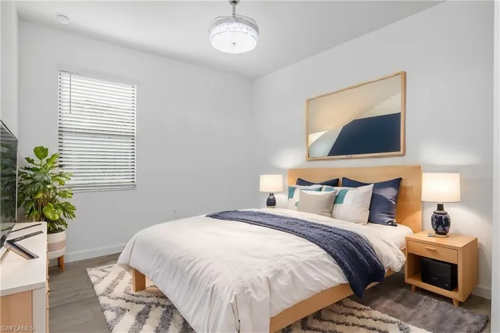 Spacious guest bedroom at the front of the home includes chandelier/ceiling fan and plenty of natural light. (furniture digitally added)