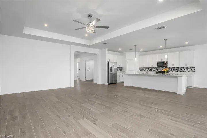 Open floor plan featuring great room, kitchen, dining room, with lanai.