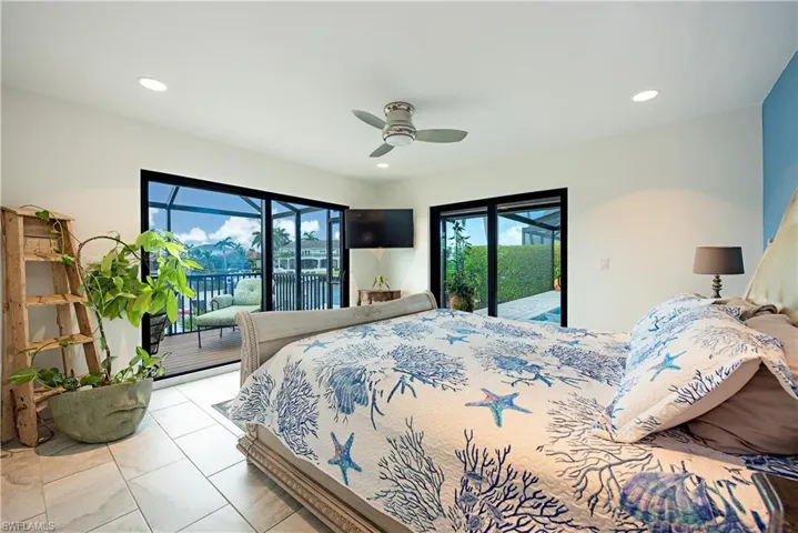 Tiled bedroom featuring access to outside, recessed lighting, and a ceiling fan