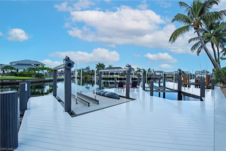 Dock area with boat lift and a water view
