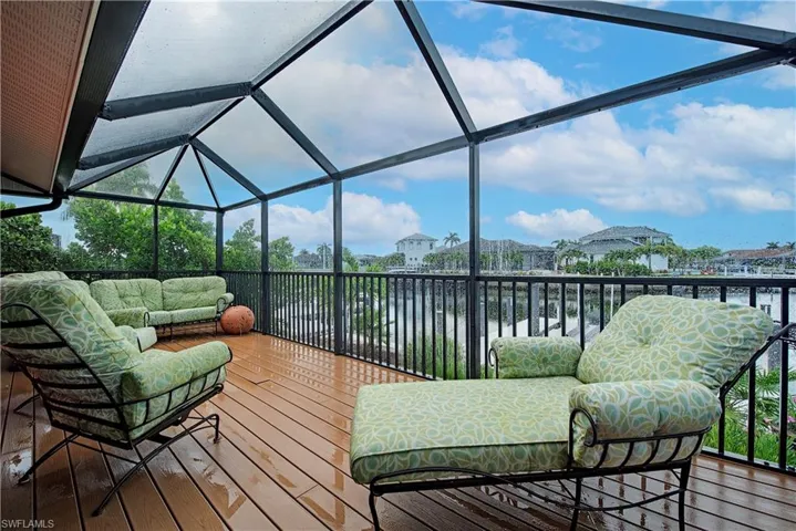 Wooden deck featuring an outdoor hangout area and a water view