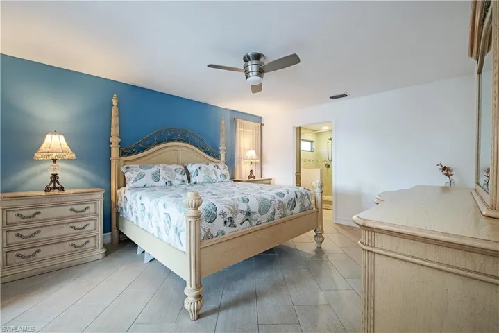 Bedroom with ensuite bath and ceiling fan
