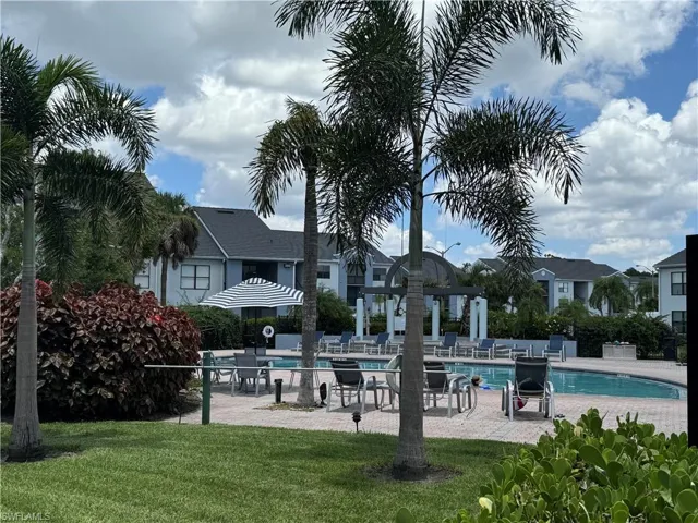View of community pool with a yard and a patio