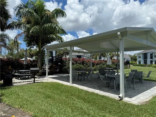 View of home's community with a yard and a patio