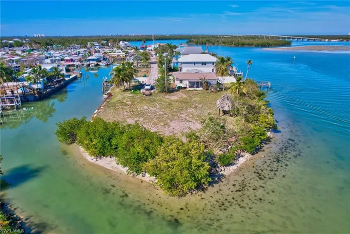 Aerial view featuring a beach view and a water view