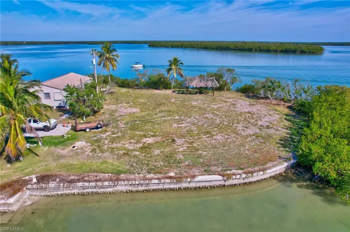 Birds eye view of property with a water view