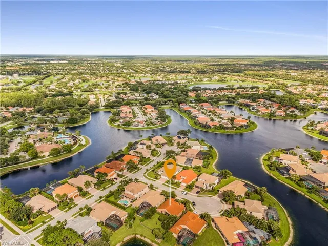Aerial perspective showcasing a residential community with numerous water features