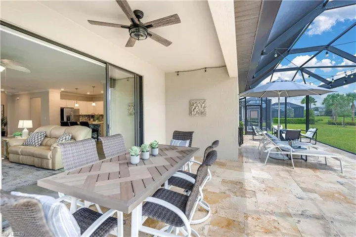 View of lanai with  fan, dining and lounging area.