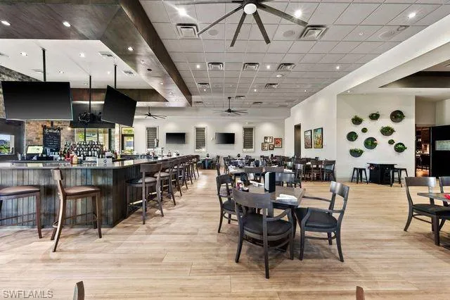Dining room featuring ceiling fan, light wood-type flooring, and a drop ceiling