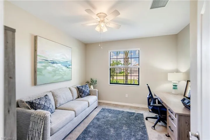 Carpeted home office with ceiling fan