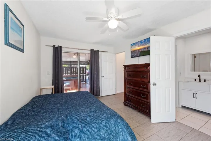 Bedroom with access to outside, a textured ceiling, and ceiling fan