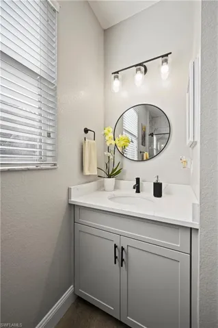 Bathroom with vanity and hardwood / wood-style floors